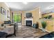 Open-concept living space with a fireplace, adjacent dining area, and sliding glass doors to the outdoors at 1414 Dolcetto Nw Trce # 14, Kennesaw, GA 30152