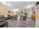 Open-concept living room featuring wood floors, neutral paint, and direct access to the kitchen and dining area at 1414 Dolcetto Nw Trce # 14, Kennesaw, GA 30152