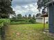 Spacious backyard view featuring lush greenery and a detached garage at 2268 Newnan St, Atlanta, GA 30344