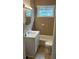 Bathroom features a white vanity, tiled walls, a window, and a combined shower and bathtub at 2268 Newnan St, Atlanta, GA 30344