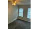 Bedroom featuring two windows, carpeting, neutral walls, and a lighted ceiling fan at 2268 Newnan St, Atlanta, GA 30344