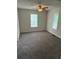 Cozy bedroom featuring neutral walls, plush gray carpeting, and a ceiling fan with integrated lighting at 2268 Newnan St, Atlanta, GA 30344