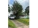 Charming single-story home nestled among mature trees, showcasing a cozy front porch at 2268 Newnan St, Atlanta, GA 30344