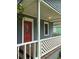 Close-up of the front porch with a distinctive red door and decorative railing at 2268 Newnan St, Atlanta, GA 30344