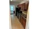 Kitchen features tile floor, wood cabinets, black appliances and view into living area at 2268 Newnan St, Atlanta, GA 30344