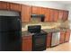 Traditional kitchen with wood cabinets, black appliances and backsplash tiles at 2268 Newnan St, Atlanta, GA 30344