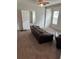 Carpeted living room with a leather sofa, fan, and window for natural light at 2268 Newnan St, Atlanta, GA 30344