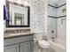 Cozy bathroom with grey granite sink top, dog themed wallpaper and a shower-tub combo at 764 Stokeswood Se Ave, Atlanta, GA 30316