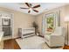 Bright Bedroom with crib, cozy armchair, and ensuite bathroom at 764 Stokeswood Se Ave, Atlanta, GA 30316