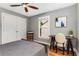Neutral bedroom features a ceiling fan, closet, and desk with a chair near a window at 764 Stokeswood Se Ave, Atlanta, GA 30316