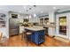 Beautiful kitchen features a blue island with granite countertops, stainless appliances, and hardwood floors at 764 Stokeswood Se Ave, Atlanta, GA 30316