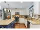 Bright kitchen featuring granite countertops, stainless steel appliances, mosaic backsplash, and hardwood floors at 764 Stokeswood Se Ave, Atlanta, GA 30316
