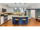 Bright kitchen featuring a blue island with granite countertops, stainless appliances, and hardwood floors at 764 Stokeswood Se Ave, Atlanta, GA 30316