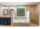 Luxurious bathroom with double vanity, soaking tub, and glass block window at 764 Stokeswood Se Ave, Atlanta, GA 30316