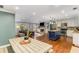 Open concept living space with dining area, kitchen with island, and cozy living room with fireplace at 764 Stokeswood Se Ave, Atlanta, GA 30316