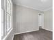 Bedroom featuring wood-look floors, beadboard paneling, and a large window at 1641 Rockcliff Se Pl, Atlanta, GA 30316