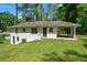 Two-story home with brick exterior, carport, and a well-maintained lawn, offering curb appeal and outdoor living space at 1641 Rockcliff Se Pl, Atlanta, GA 30316