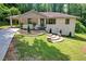 Charming home showcasing a stone facade, landscaped front yard, and brick steps leading to the entrance at 1641 Rockcliff Se Pl, Atlanta, GA 30316