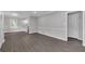 Open-concept living space with gray paint, white trim, and modern gray wood floors at 1641 Rockcliff Se Pl, Atlanta, GA 30316