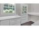 Mud room featuring white cabinets, quartz countertop, and a vintage-style door to the backyard at 1641 Rockcliff Se Pl, Atlanta, GA 30316
