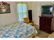 Modest bedroom includes a bed with patterned bedding, dresser, and a small TV at 1968 Don Juan Ln, Decatur, GA 30032