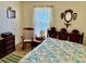 Bedroom features a double bed with a floral comforter, wooden furniture, and decorative wall hangings at 1968 Don Juan Ln, Decatur, GA 30032