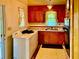 Bright kitchen with vintage cabinets, double sinks, laundry machine, and natural light at 1968 Don Juan Ln, Decatur, GA 30032