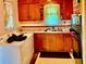 View of older kitchen featuring wood cabinets, double sink, window, and adjacent washing machine at 1968 Don Juan Ln, Decatur, GA 30032