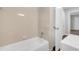 Bathroom with a white tiled bathtub with shower features and a single sink vanity at 2683 Rockcliff Se Rd, Atlanta, GA 30316
