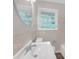 Bathroom showcasing a large vanity, round mirror, and natural light from window at 2683 Rockcliff Se Rd, Atlanta, GA 30316