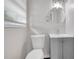 Bathroom with a modern round mirror, toilet, and single sink vanity with gray cabinet at 2683 Rockcliff Se Rd, Atlanta, GA 30316