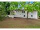 The backyard exterior of a house with a covered porch, white brick, and mulch bed at 2683 Rockcliff Se Rd, Atlanta, GA 30316