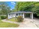 Home with a carport, white brick exterior, neat landscaping, and a walkway leading to the entrance at 2683 Rockcliff Se Rd, Atlanta, GA 30316