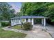 Home with a carport, white brick exterior, neat landscaping, and a walkway leading to the entrance at 2683 Rockcliff Se Rd, Atlanta, GA 30316