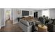 Modern living room featuring a large screen TV, plush furnishings, and hardwood floors at 2683 Rockcliff Se Rd, Atlanta, GA 30316