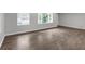 A bright living room showcasing stylish flooring, fresh paint, and ample natural light from large windows at 2683 Rockcliff Se Rd, Atlanta, GA 30316