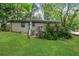 Backyard view of the home featuring a well-maintained lawn and wooden deck at 3093 Del Monico Dr, Decatur, GA 30032