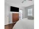 Modern bedroom with mounted TV and white linen bedding at 3093 Del Monico Dr, Decatur, GA 30032