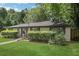 Lovely single-story home with lush landscaping and manicured lawn, blending privacy and curb appeal at 3093 Del Monico Dr, Decatur, GA 30032