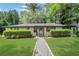 Charming home with well-manicured front lawn and stone walkway at 3093 Del Monico Dr, Decatur, GA 30032