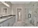Elegant bathroom with double vanity, marble shower, and patterned tile flooring at 454 Connally Se St, Atlanta, GA 30312