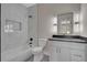 Modern bathroom with marble tile, a sleek vanity, and a bathtub with shower at 454 Connally Se St, Atlanta, GA 30312