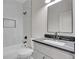 Bathroom featuring a tub with a shower and a modern vanity with a sleek mirror at 454 Connally Se St, Atlanta, GA 30312