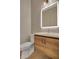 Modern bathroom with a wood vanity, a backlit mirror, and sleek fixtures at 454 Connally Se St, Atlanta, GA 30312