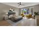 Relaxing bedroom with large windows, a ceiling fan, and stylish furniture at 454 Connally Se St, Atlanta, GA 30312