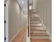 Hallway with stairway with wooden steps and a white handrail at 454 Connally Se St, Atlanta, GA 30312
