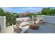 Relax on the spacious roof deck featuring stylish outdoor furniture and panoramic city views at 454 Connally Se St, Atlanta, GA 30312