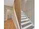 Modern staircase with white risers and stained treads, complemented by natural light at 454 Connally Se St, Atlanta, GA 30312