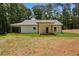 Backyard view featuring a new construction home with a covered patio and a spacious lawn at Lot 2 Harmony Rd, Temple, GA 30179