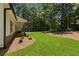 Charming single-story home featuring dark trim windows and a well-maintained lawn with lush greenery at Lot 2 Harmony Rd, Temple, GA 30179